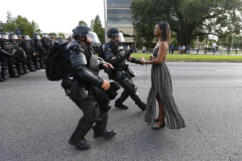 Protester Ieshia Evans is detained by law enforcement near the headquarters of the Baton Rouge Police Department in Baton Rouge, Louisiana, during a demonstration against the shooting death of Alton Sterling July 9, 2016. REUTERS/Jonathan Bachman